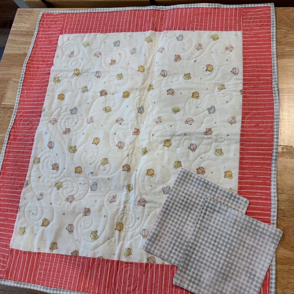Orange and white teacup tablecloth w/napkins and utensils.